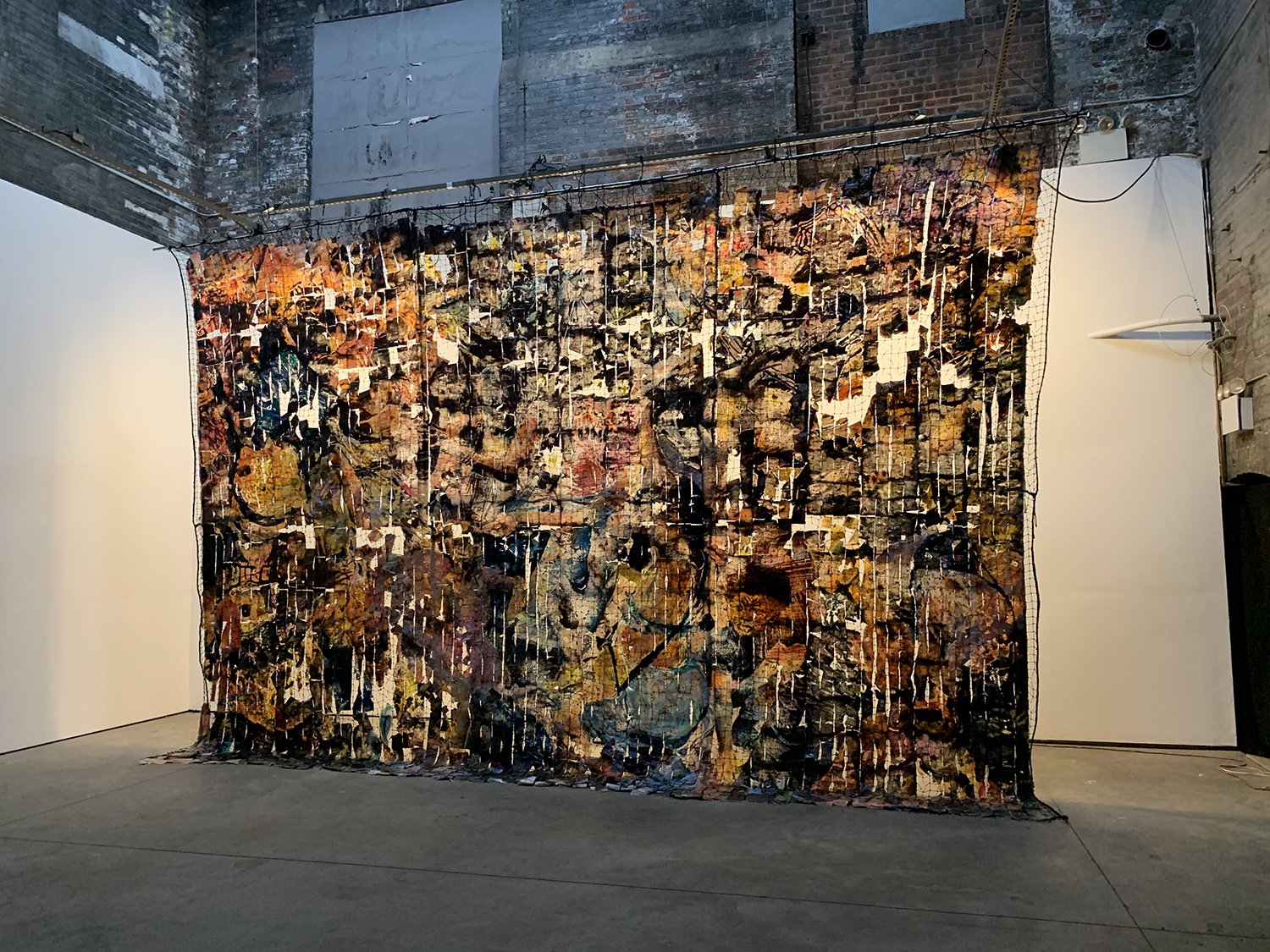 Baris Gokturk, All Saints, exhibition view at The Boiler @ ELM Foundation, 2021.Image transfer, polymer, ink, acrylic, netting, 487.7 x 731.52 cm (16 x 24 ft).Courtesy of the artist and The Boiler @ ELM Foundation.