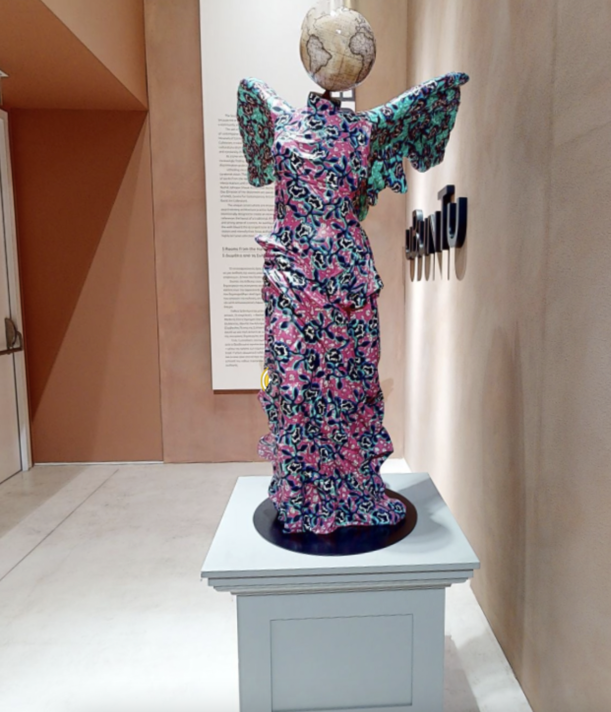 Yinka Shonibare, Winged Victory of Samothrace, 2017.Fibreglass, hand-painted with dutch wax batik pattern and bespoke hand-coloured globe, 142.5 x 87 x 92 cm.Installation view, UBUNTU: Five Rooms at the Harry David Art Collection, National Museum of Contemporary Art Athens (EMST), 2020-2021. Courtesy of the artist and The Harry David Art Collection.